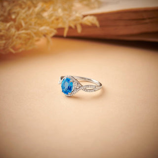 1.5 Carat Oval Shaped Swiss Blue Topaz and Diamond Twisted Ring in Sterling Silver